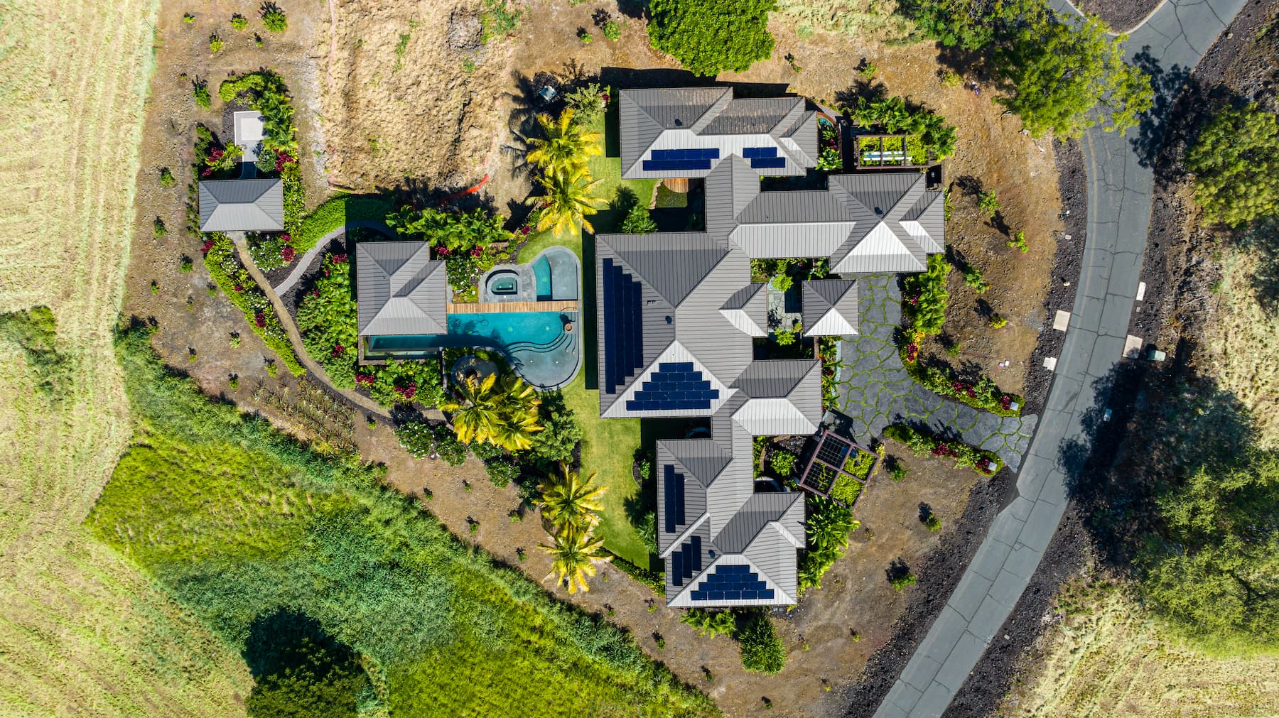 An aerial view of a home with rooftop solar panels.