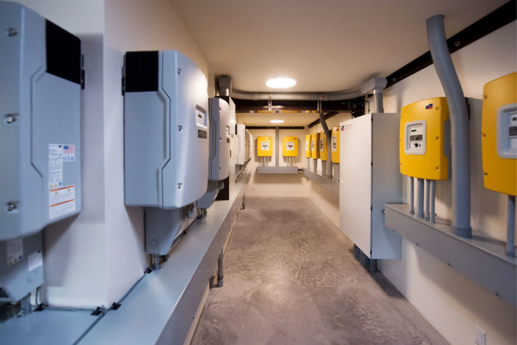 A hallway with a row of SMA inverters.