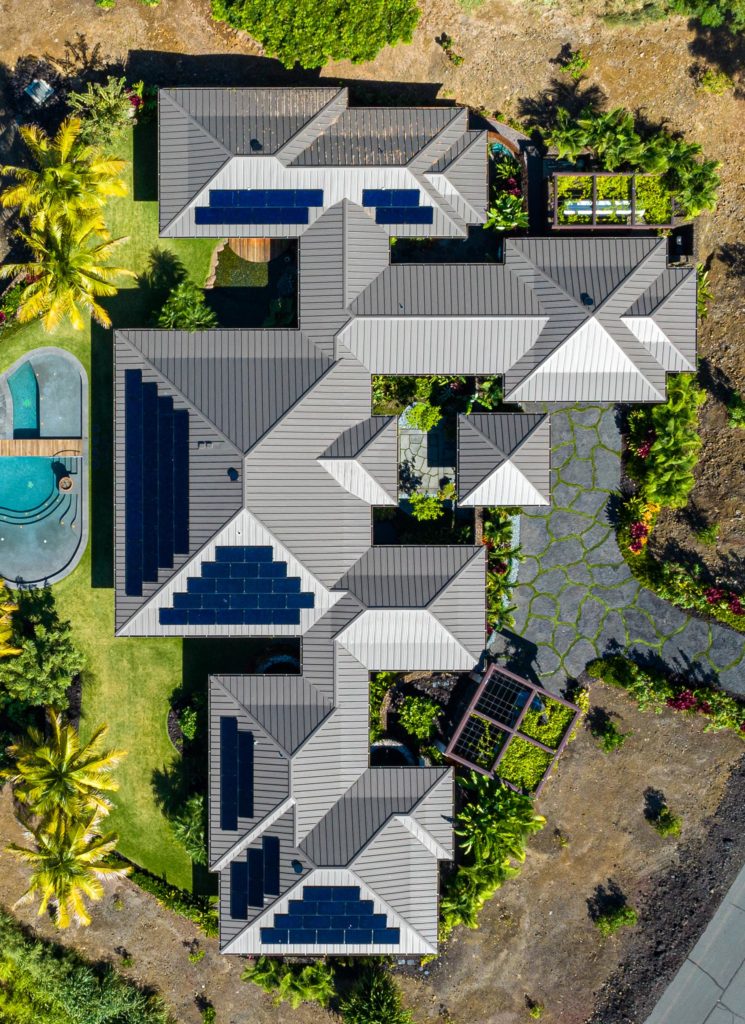 An aerial view of a house with solar panels.