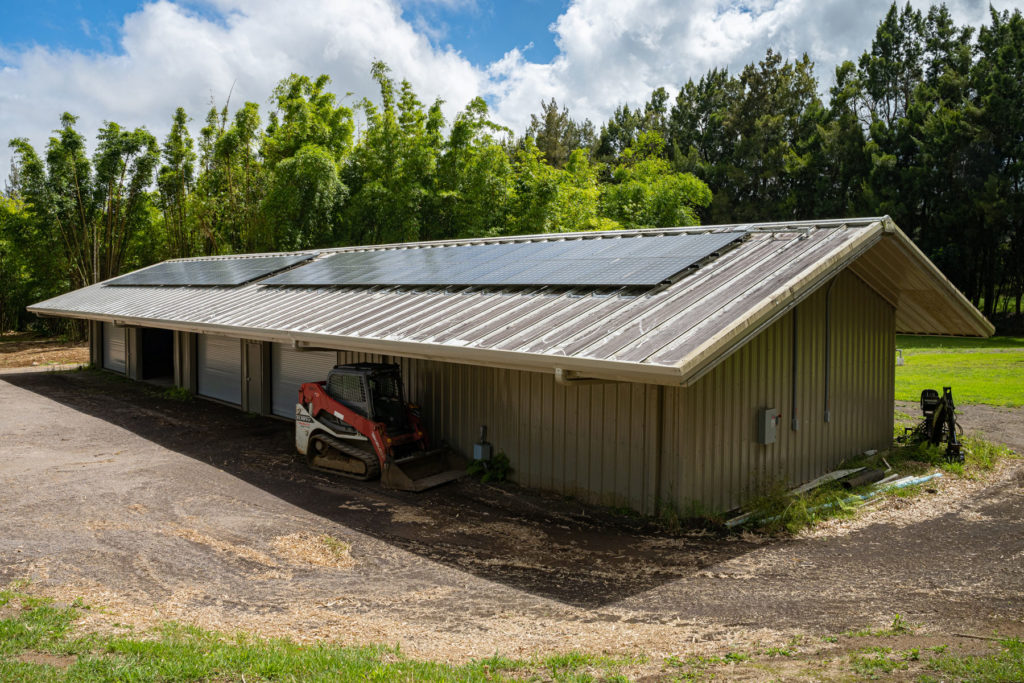 An accessory building with solar panels on the roof. 