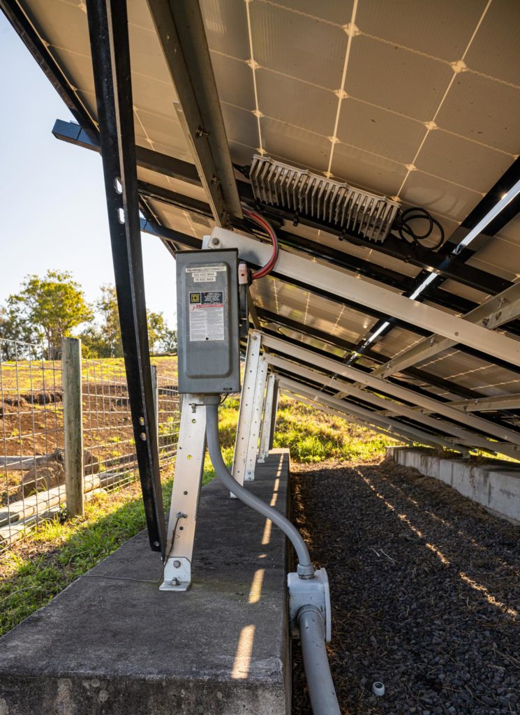 A junction box attached to a ground mounted solar array.