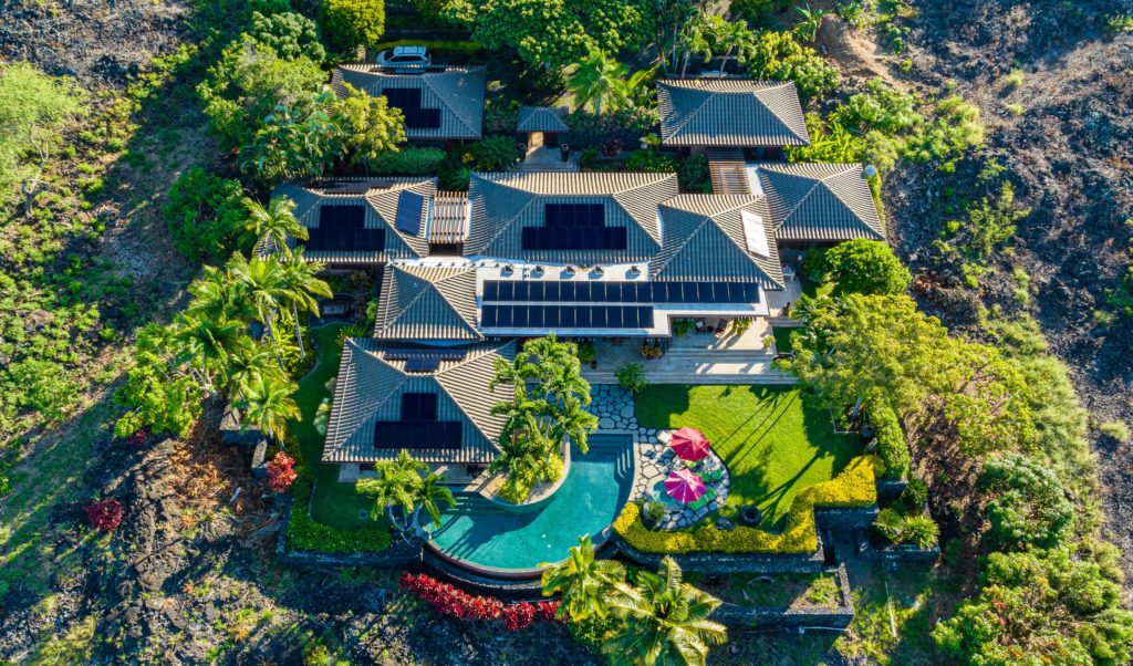 An aerial view of a resort home with solar panels in Hawaii.